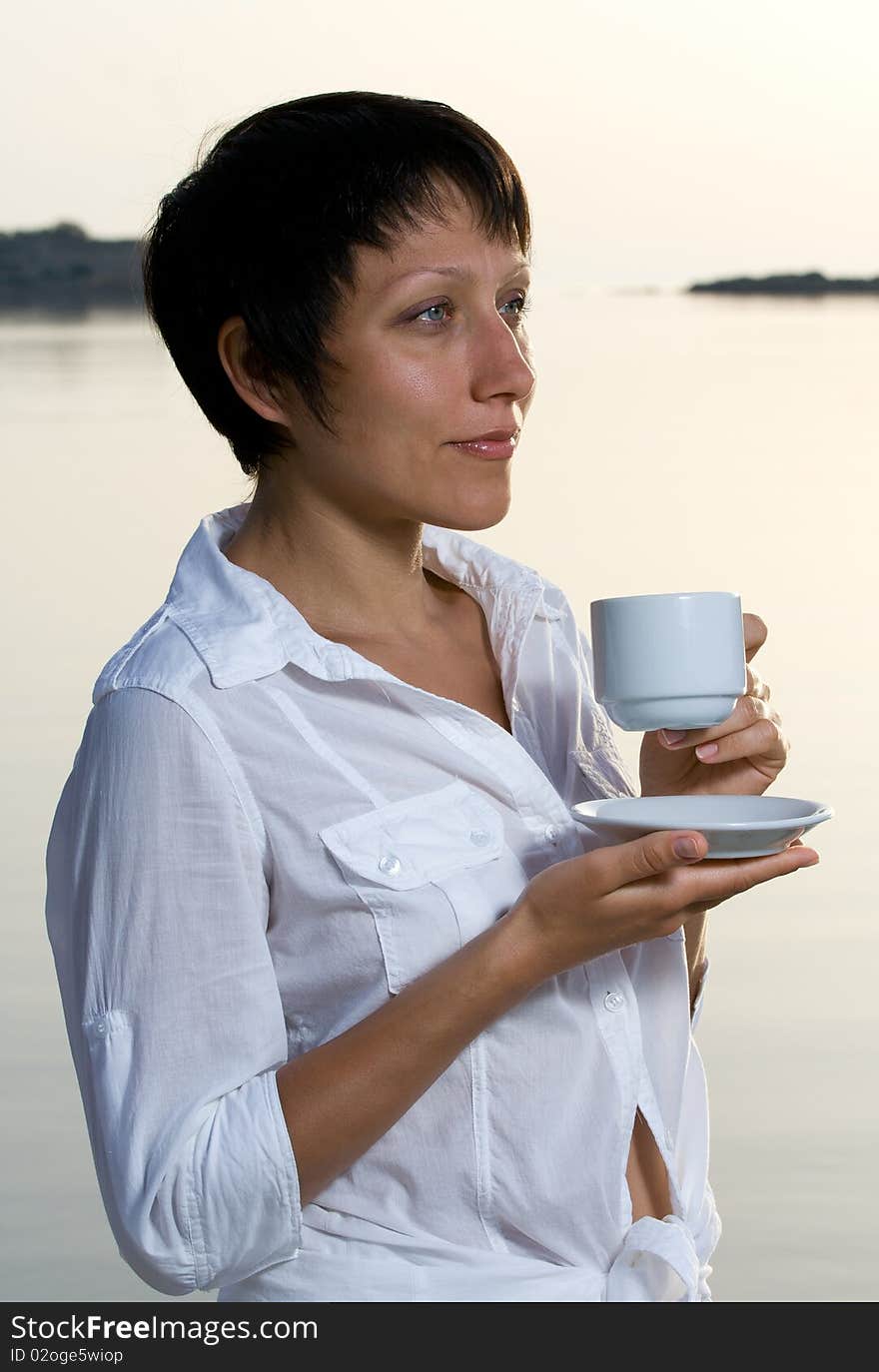 Young Woman Meets Sunrise Drinking Morning Coffee