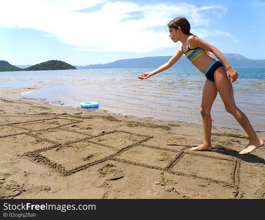 Little girl playing in the sand at the beach. Little girl playing in the sand at the beach