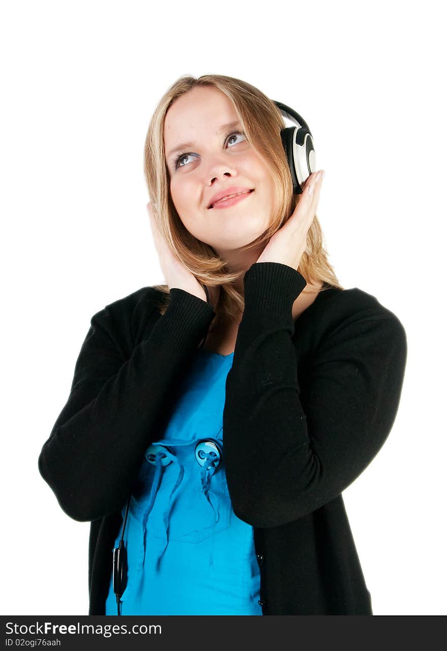 Close-up of pretty girl in headphones listening to music with pleasure. Close-up of pretty girl in headphones listening to music with pleasure