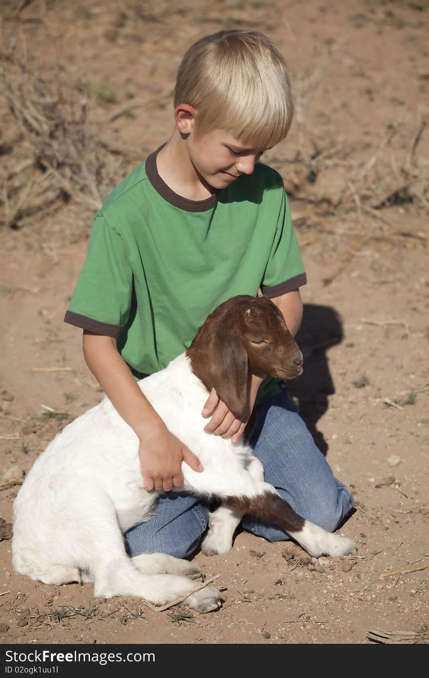 Boy green shirt with baby goat