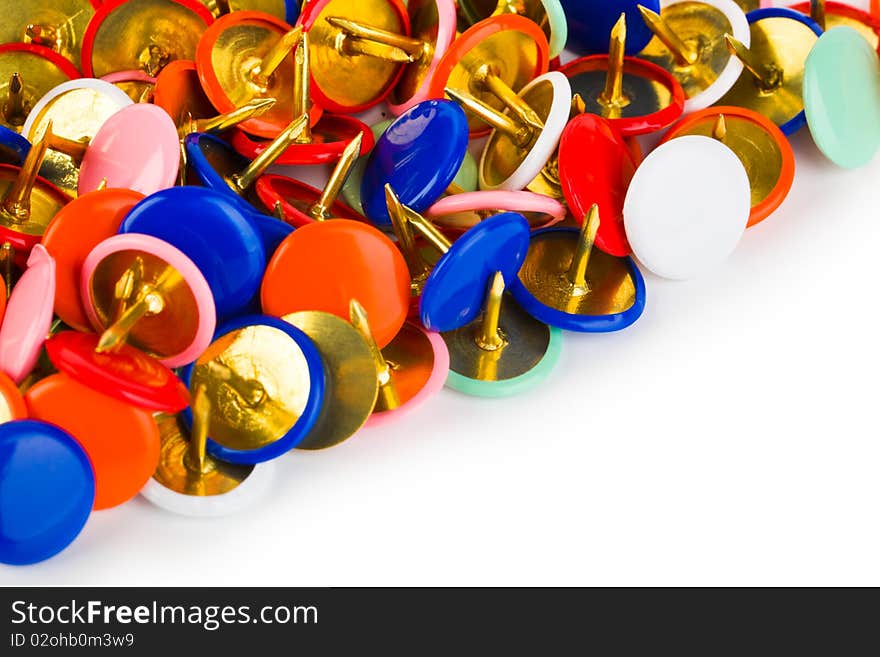 Heap of multicolored pins isolated on white background