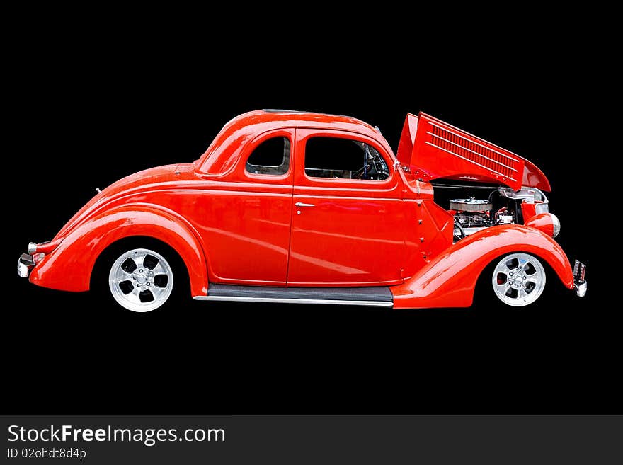 Bright red car isolated on a black background. Bright red car isolated on a black background.