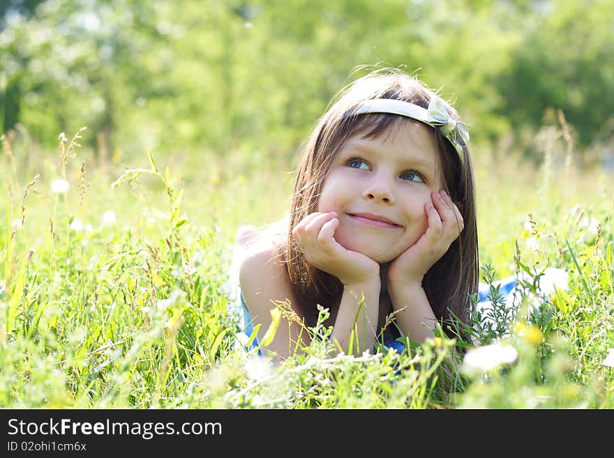 Young beautiful happy girl lays on a grass. Young beautiful happy girl lays on a grass