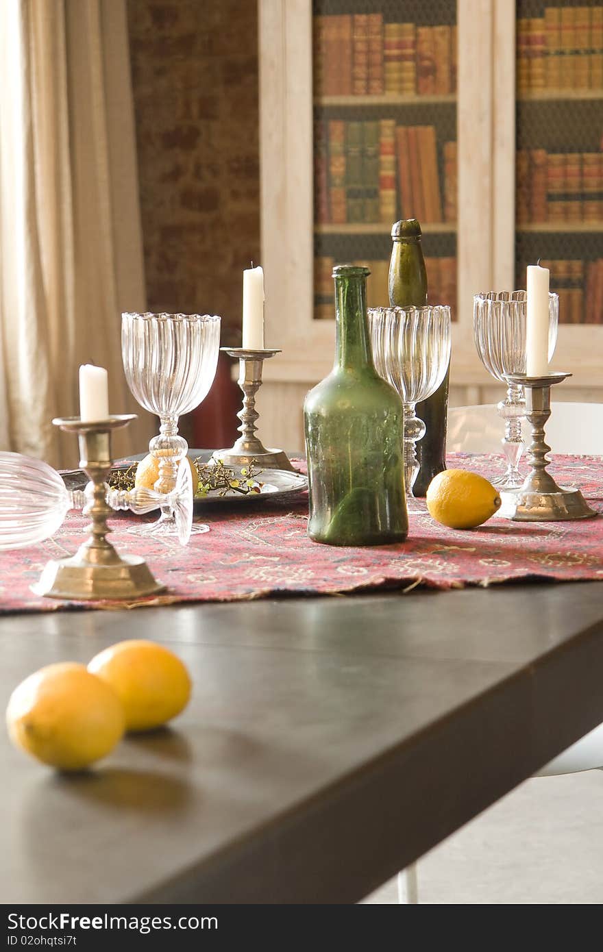 Table with bottles, candles and glasses. Table with bottles, candles and glasses