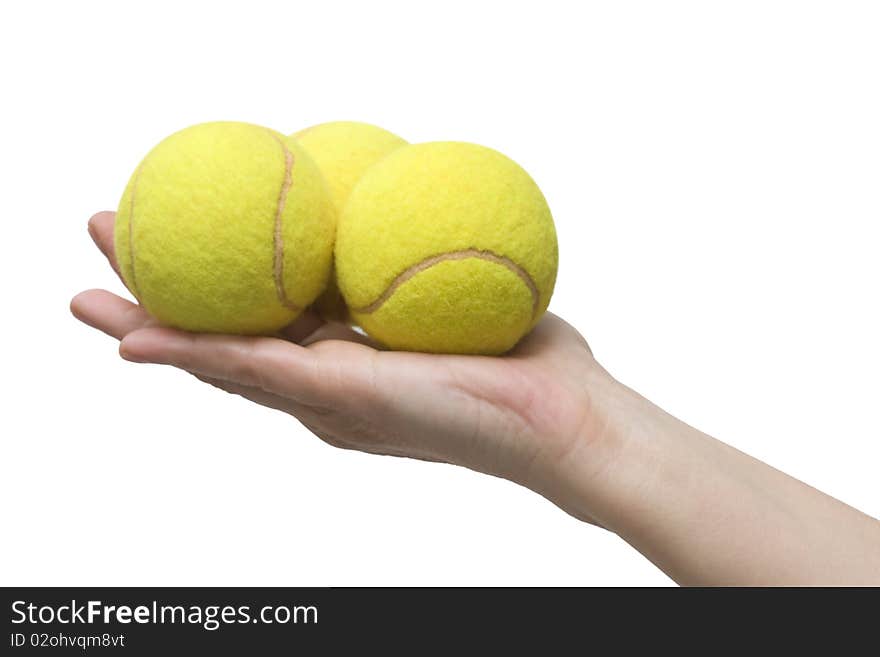 Hand holding three tennis balls