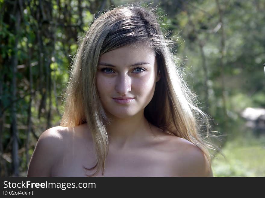 Blonde smiling in a summer forest. Blonde smiling in a summer forest