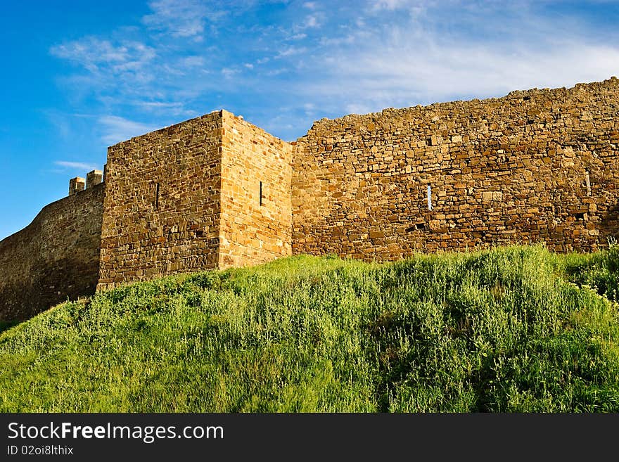 VII century Genoese fortress. Stone wall and tower. VII century Genoese fortress. Stone wall and tower.