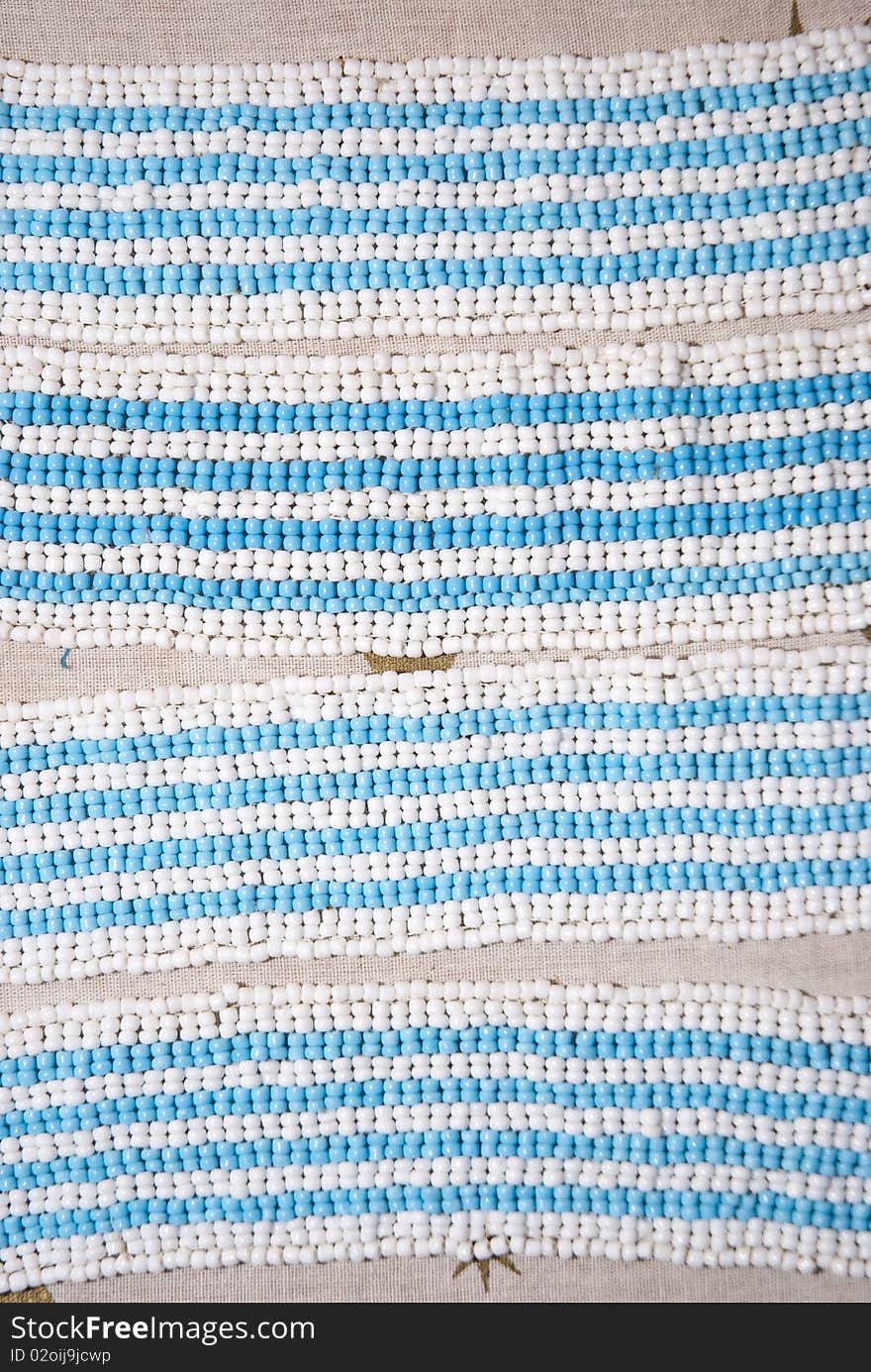 Light blue and white beads, arranged as armbands. Light blue and white beads, arranged as armbands