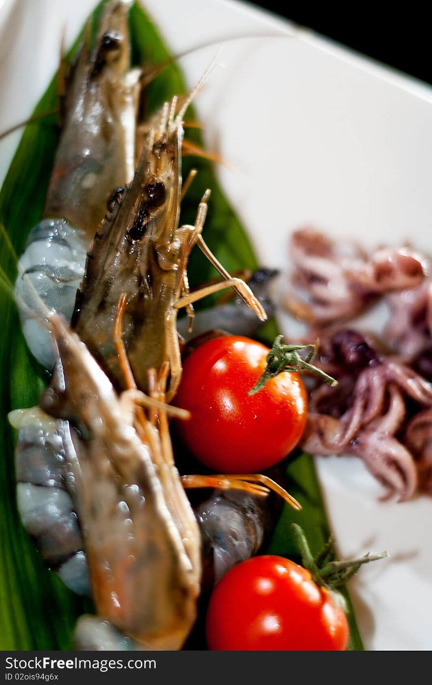 Grilled shrimps with octopus and tomatoes, isolated