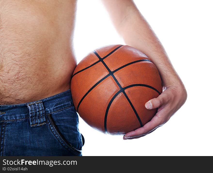 The hand holds a basketball ball resting against a torso. The hand holds a basketball ball resting against a torso