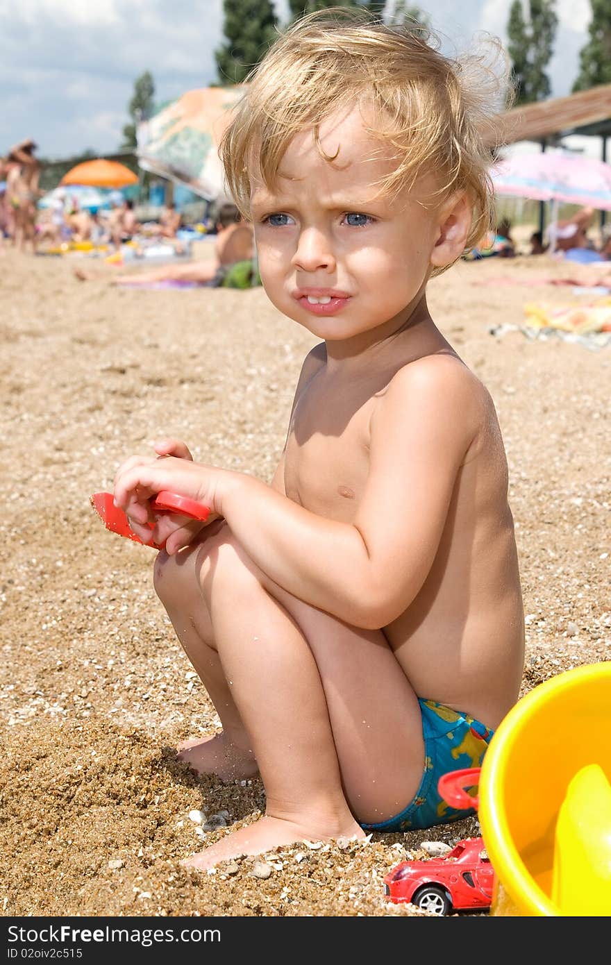 Little boy playing at the seaside at day