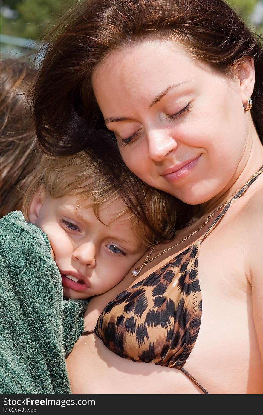 Woman holding her little son smiling. Woman holding her little son smiling