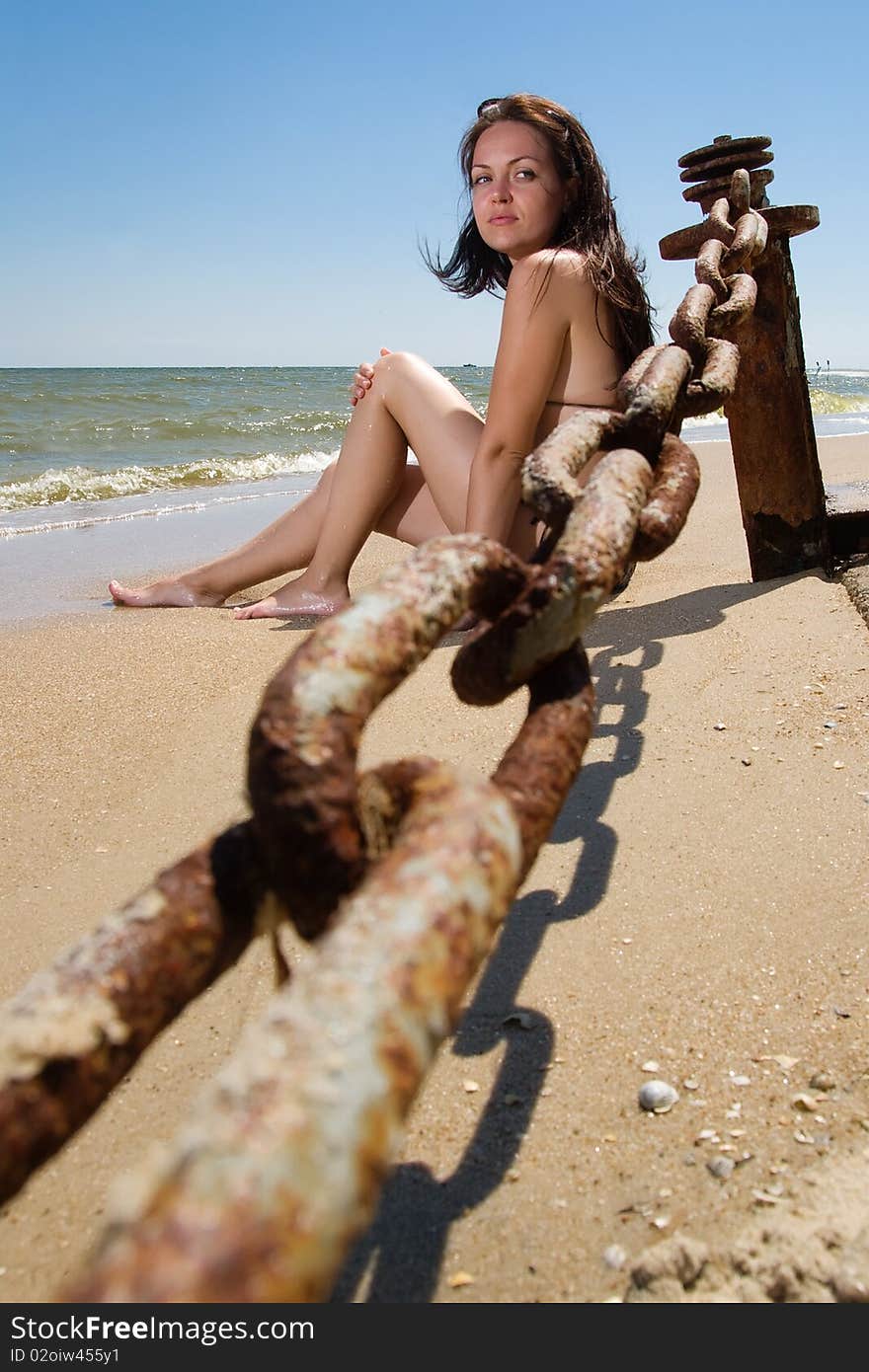 Young woman sitting at the seaside alone. Young woman sitting at the seaside alone