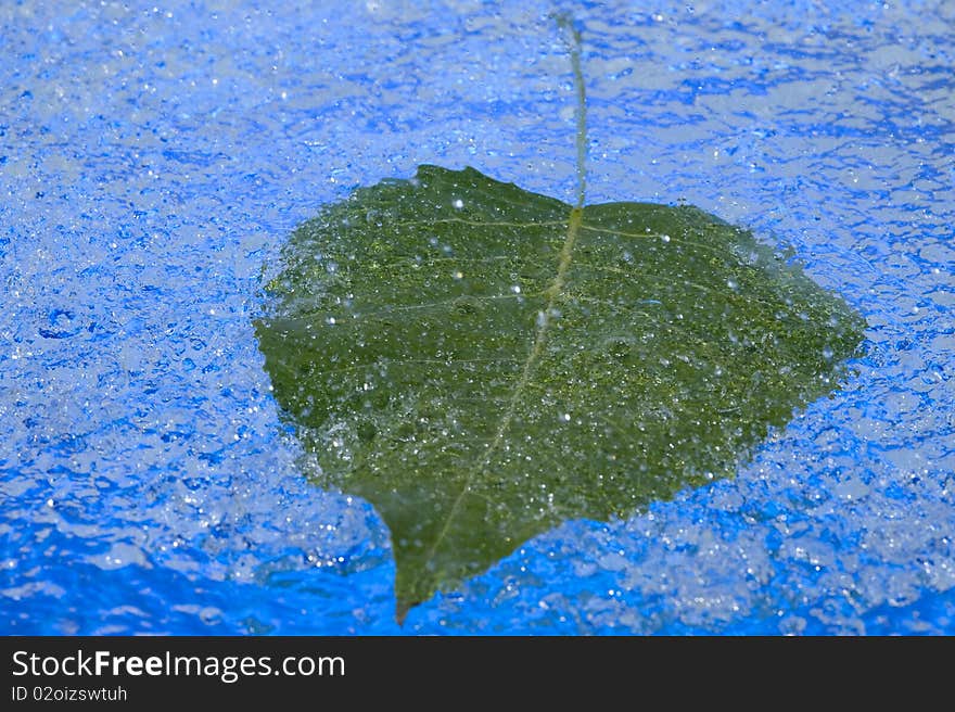 Blue background with raindrop and leaf. Blue background with raindrop and leaf