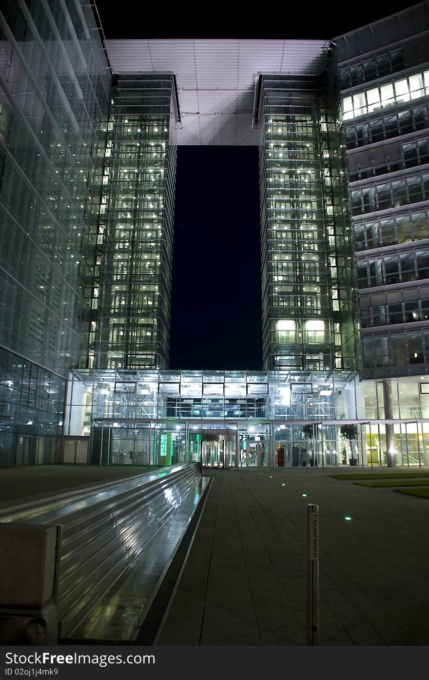 Modern building made of glass illuminated by neon lights, airportof Schwechat, Austria