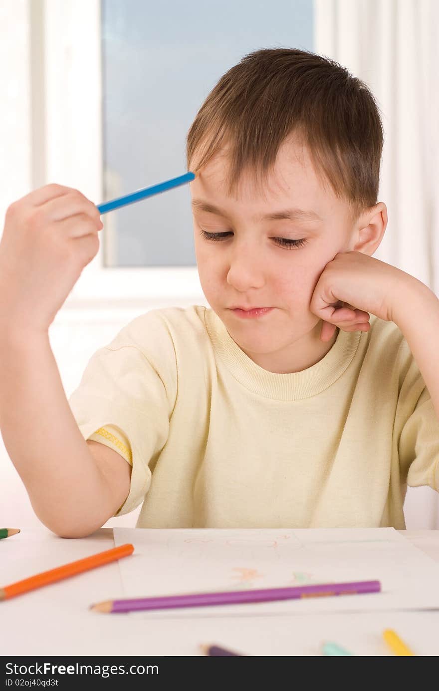 Boy With A Pencil Sitting And Draws