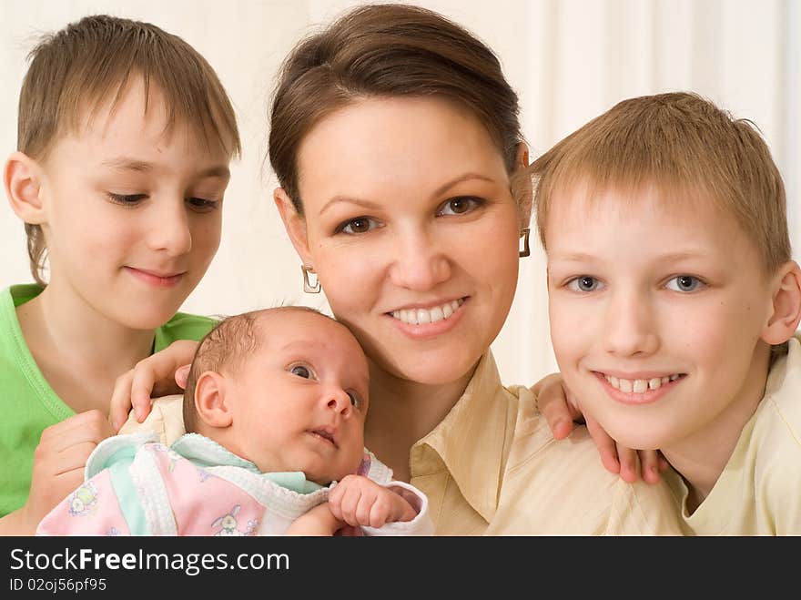 Young mother with three children standing together