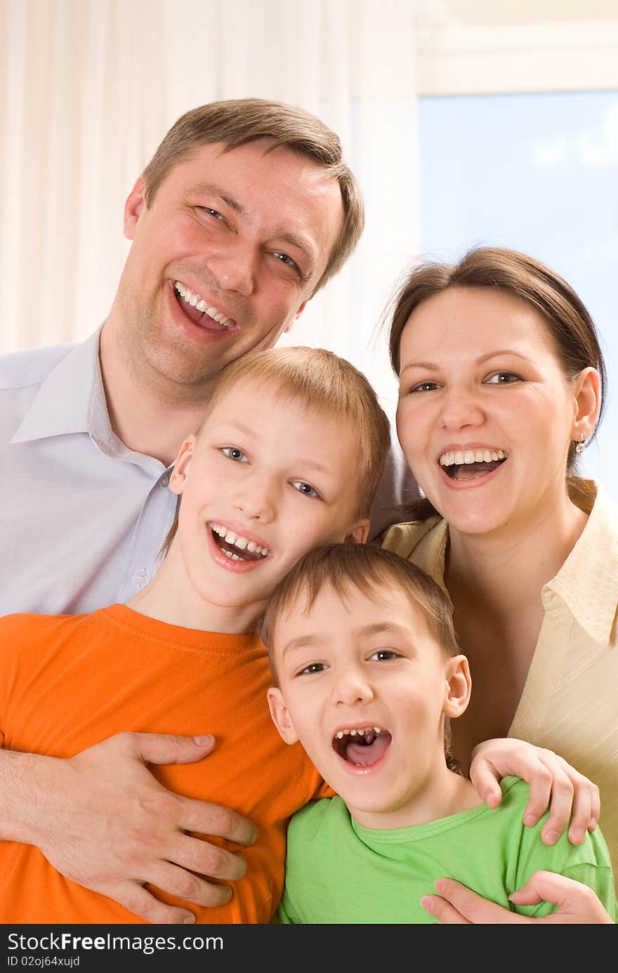 Happy family four on a light background