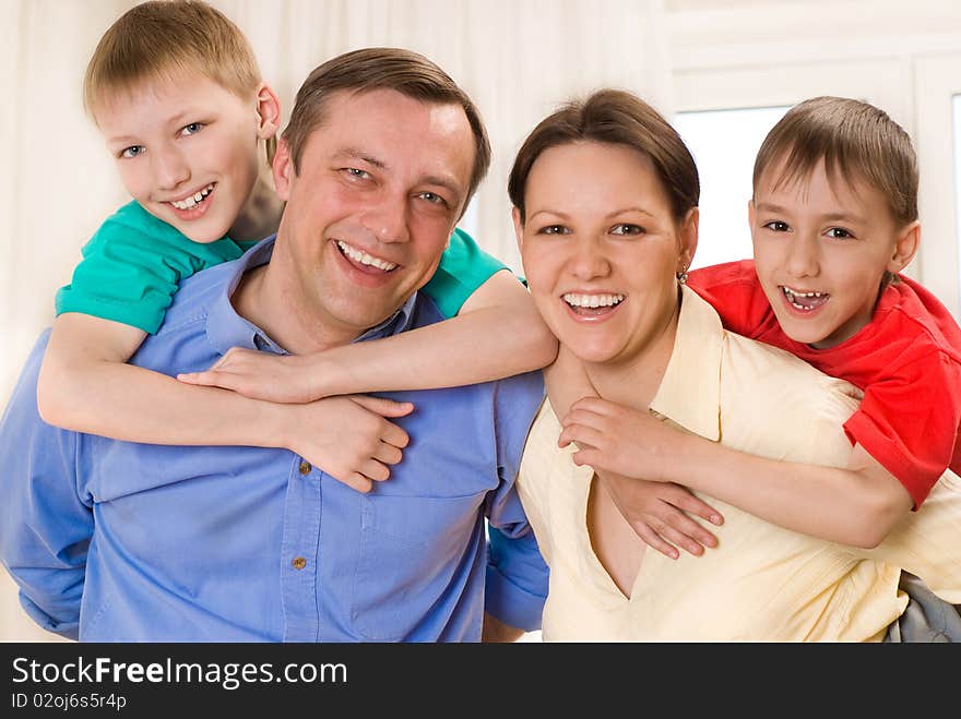 Happy family four on a light background