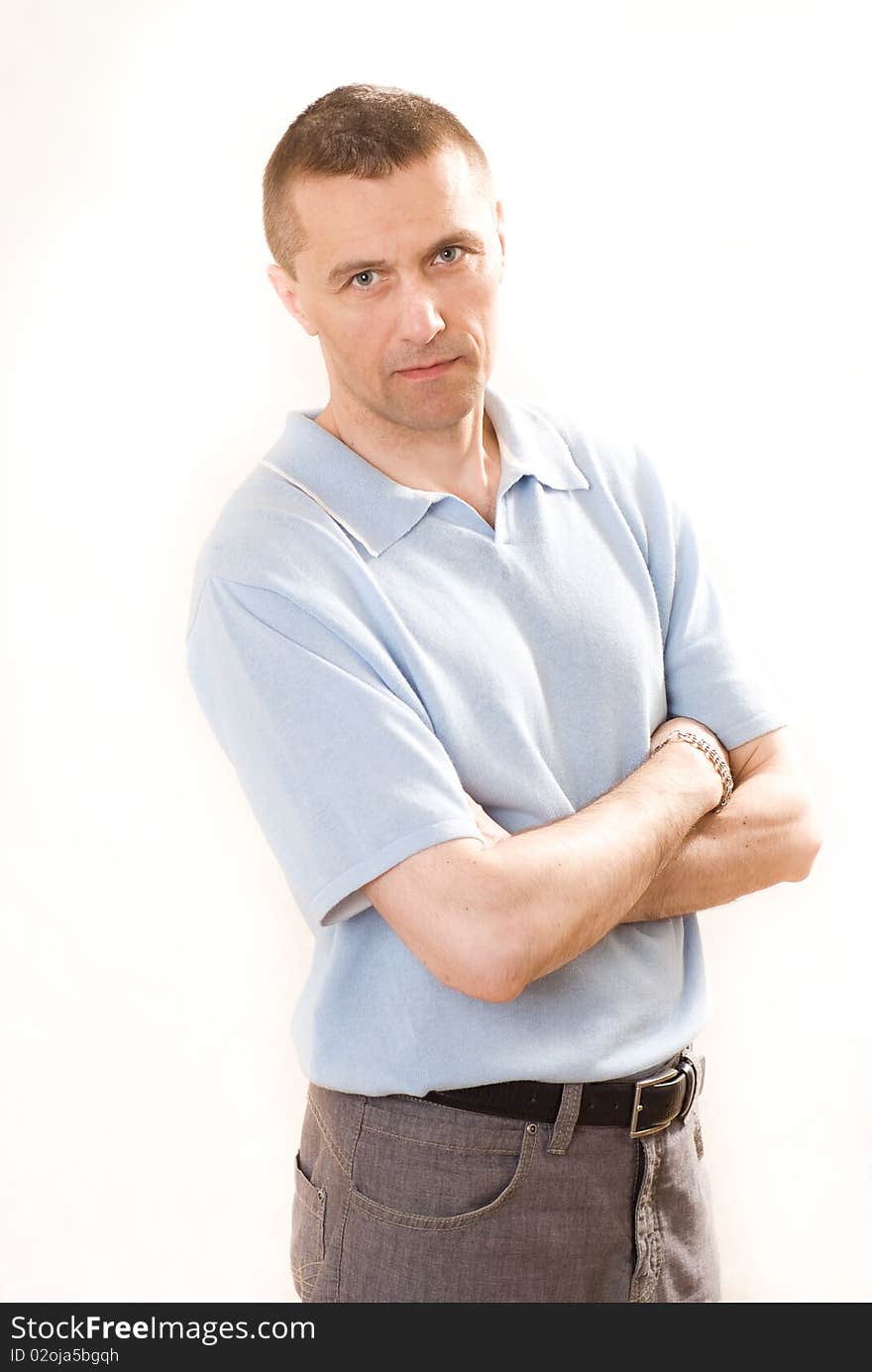 Man in a blue shirt standing on a white