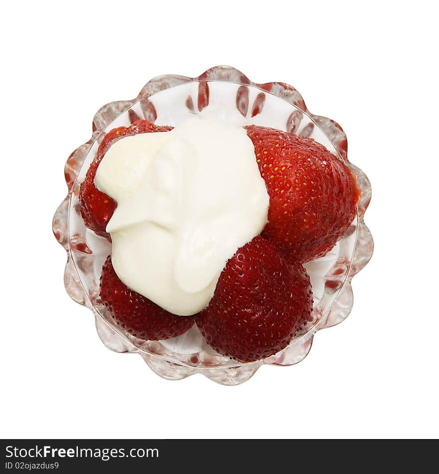 Strawberry with cream in glass plate isolated on white background