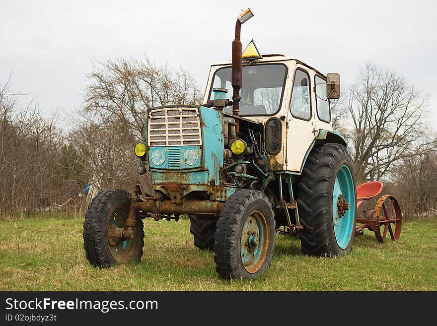 Old wheeled tractor in countryside