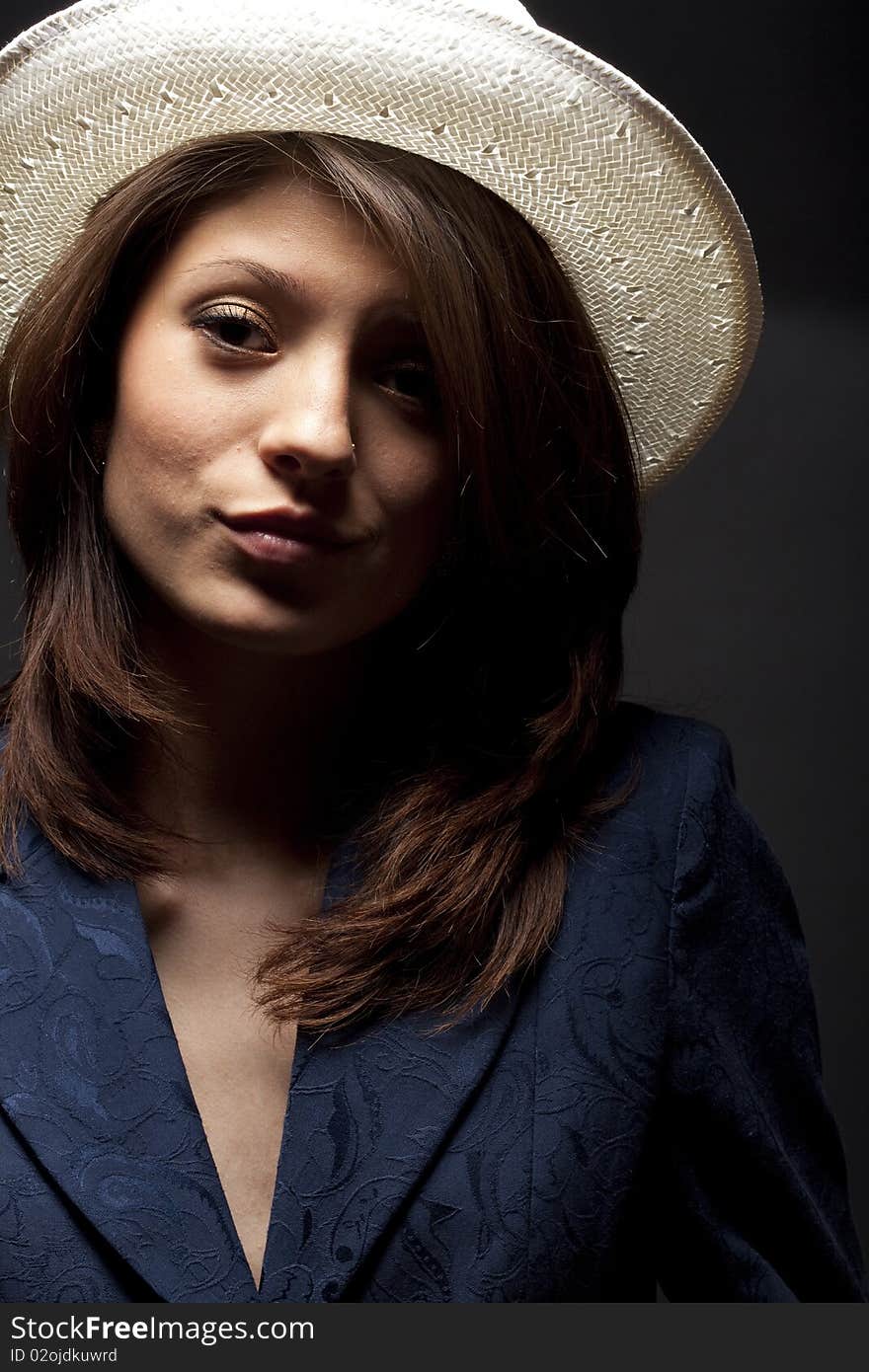 Portrait of a girl in a white hat