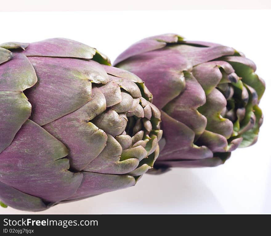 Two artichokes, white background, close up shot. Two artichokes, white background, close up shot.