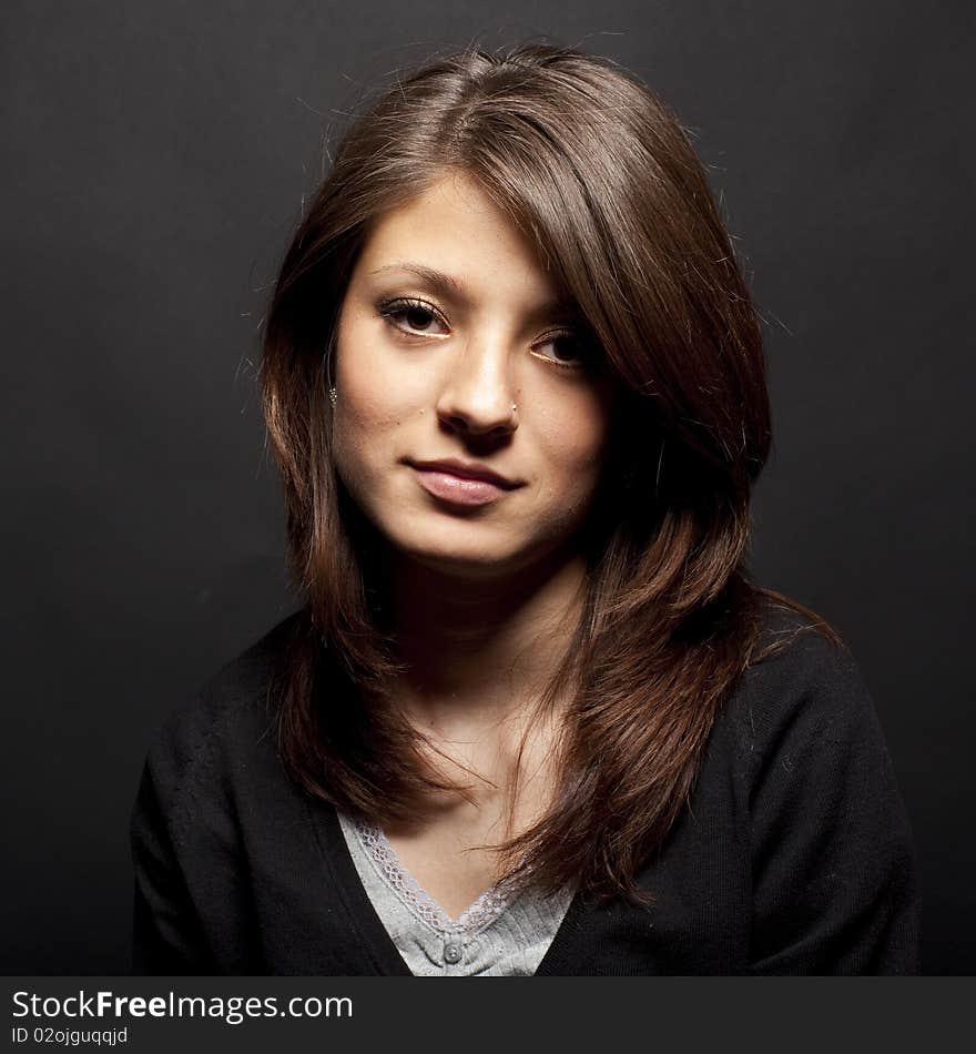 Portrait of a young girl on a black