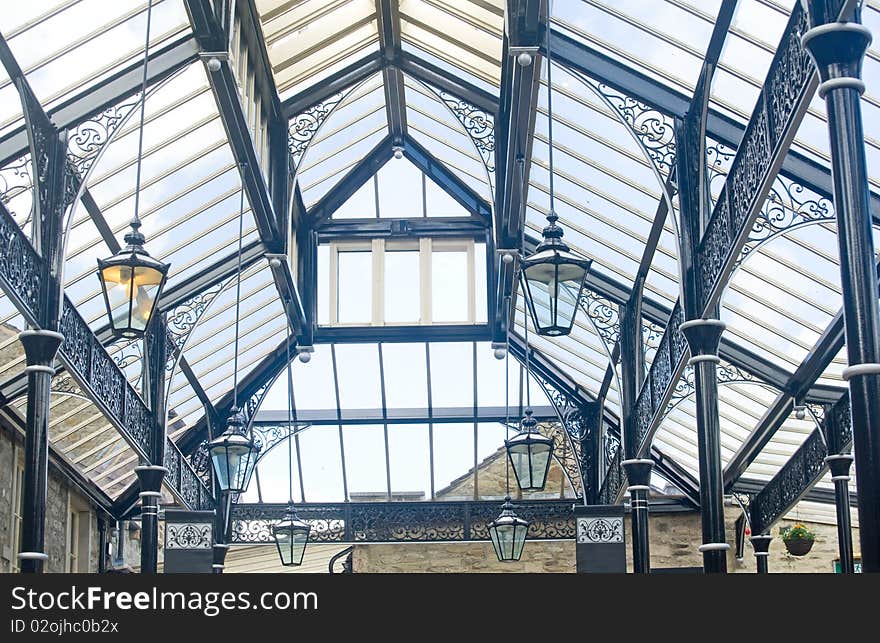 An image of the roof of a covered market made of glass and metal and allowing a bright interior and useful in bad weather. An image of the roof of a covered market made of glass and metal and allowing a bright interior and useful in bad weather.