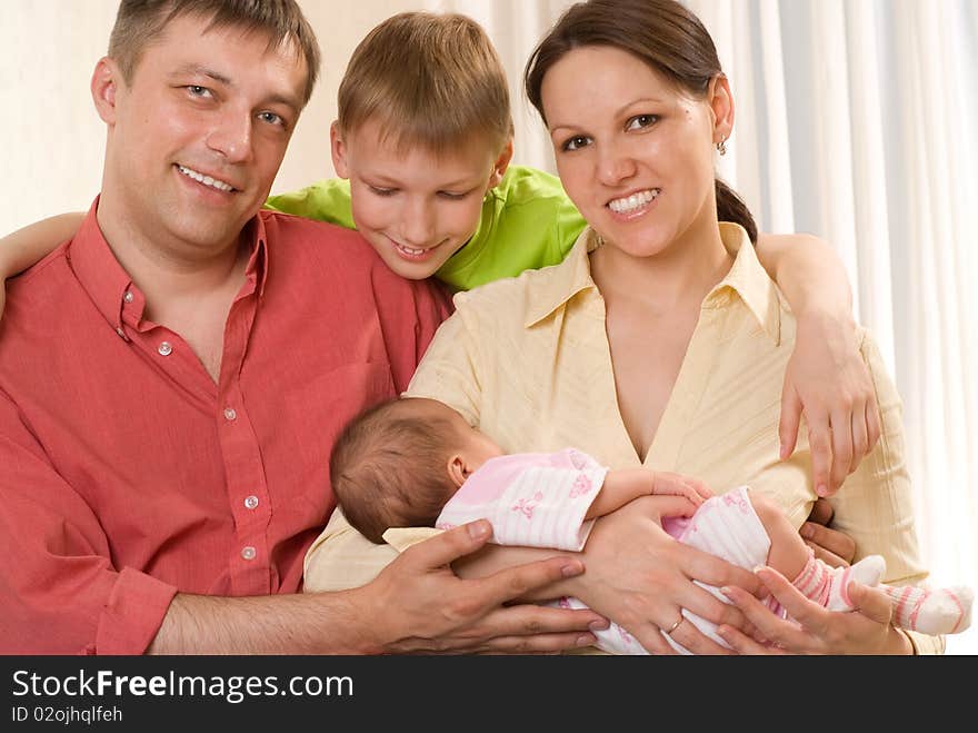 Happy smiling parents with their two children