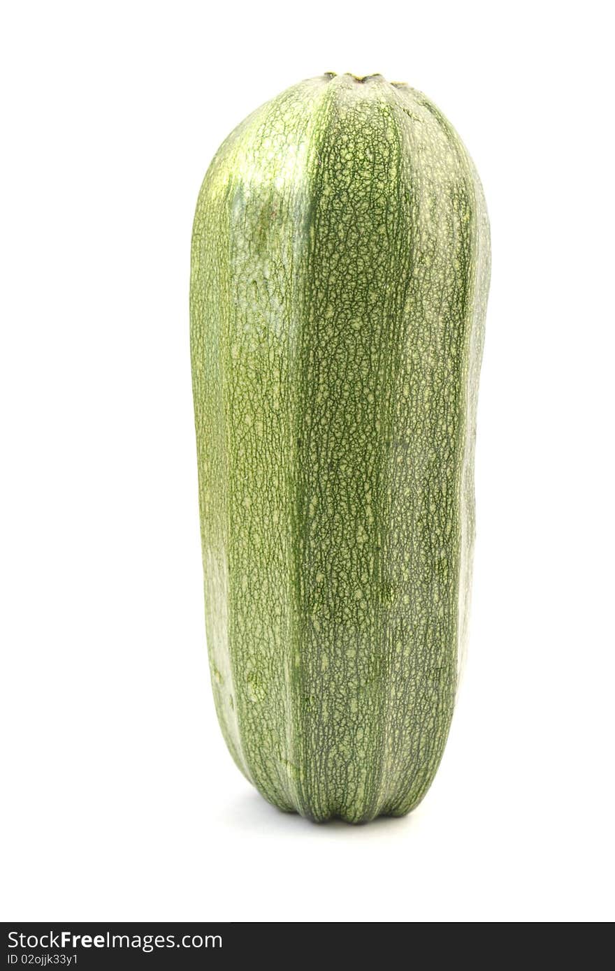 Single green zucchini isolated on white