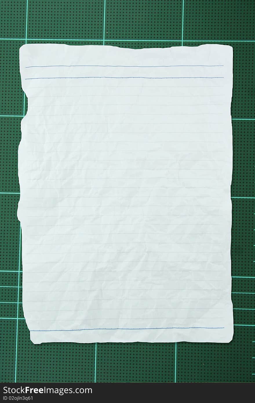 Tear white crumpled paper with line on green background. Tear white crumpled paper with line on green background