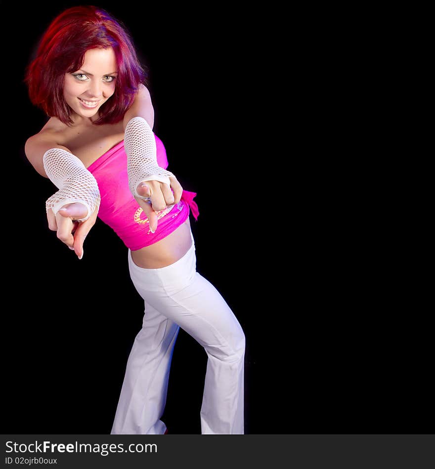 Young model with red hair pointing at the camera at a party setting.