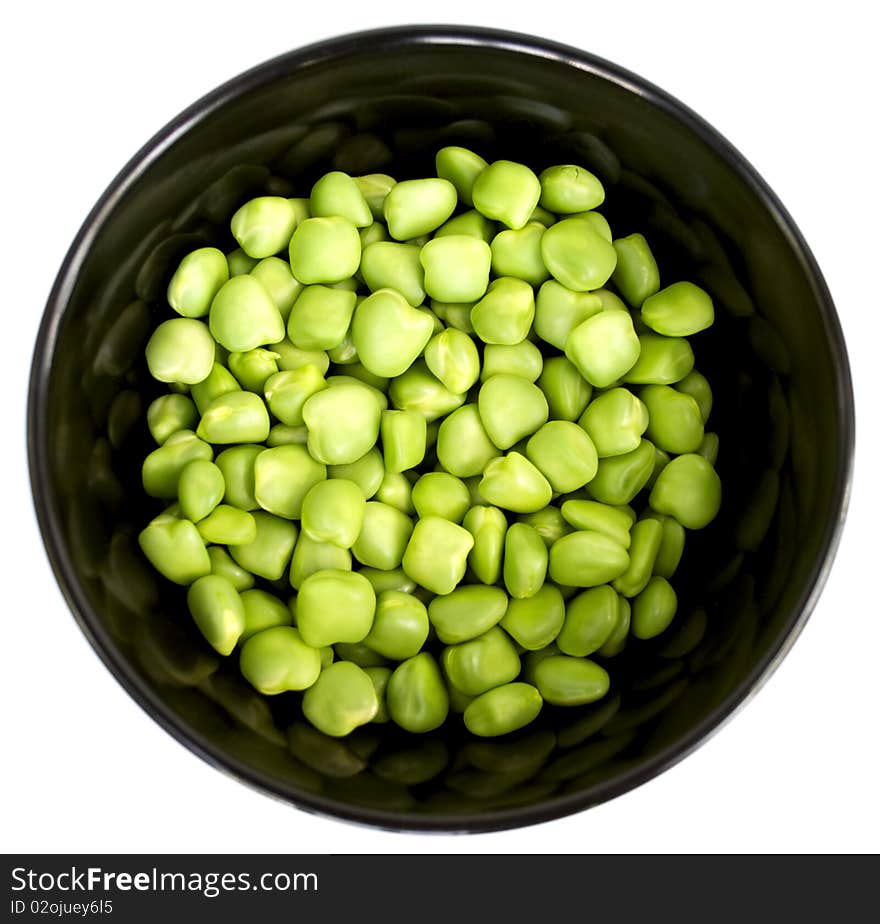 Fresh green peas in a beautiful black plate. Fresh green peas in a beautiful black plate