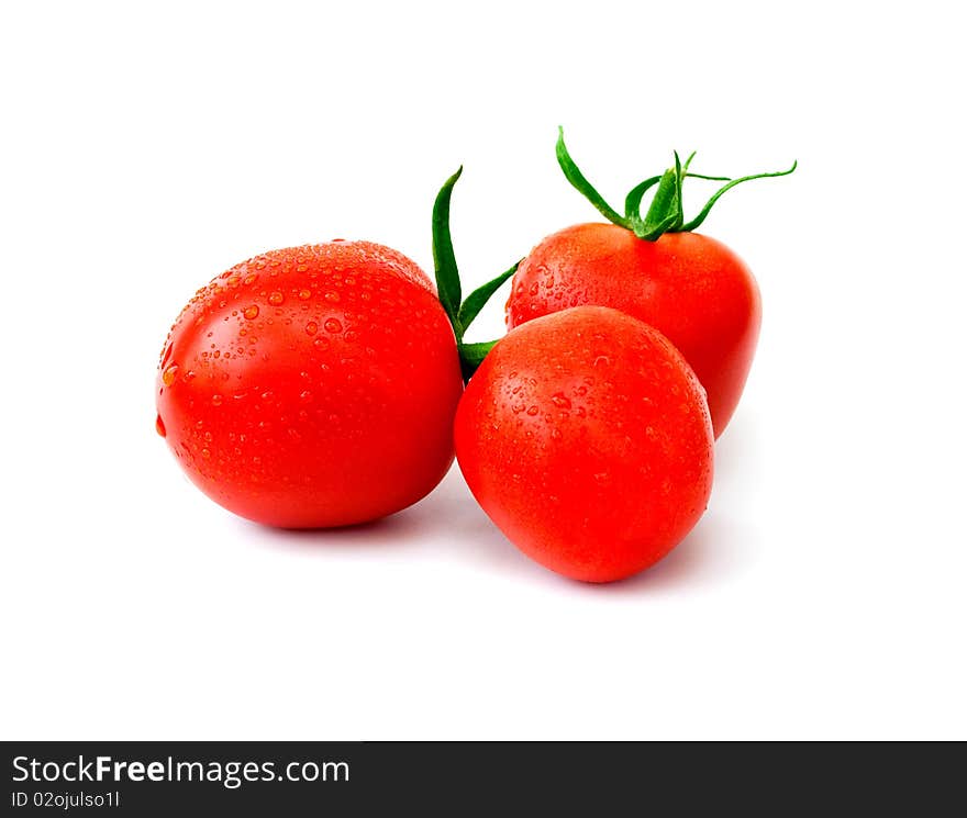 Three ripe red tomatoes with drops of water on a white background. Three ripe red tomatoes with drops of water on a white background