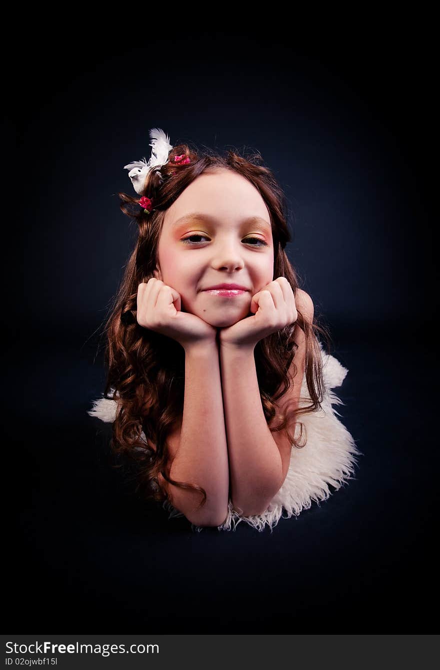 Young girl posing on black background