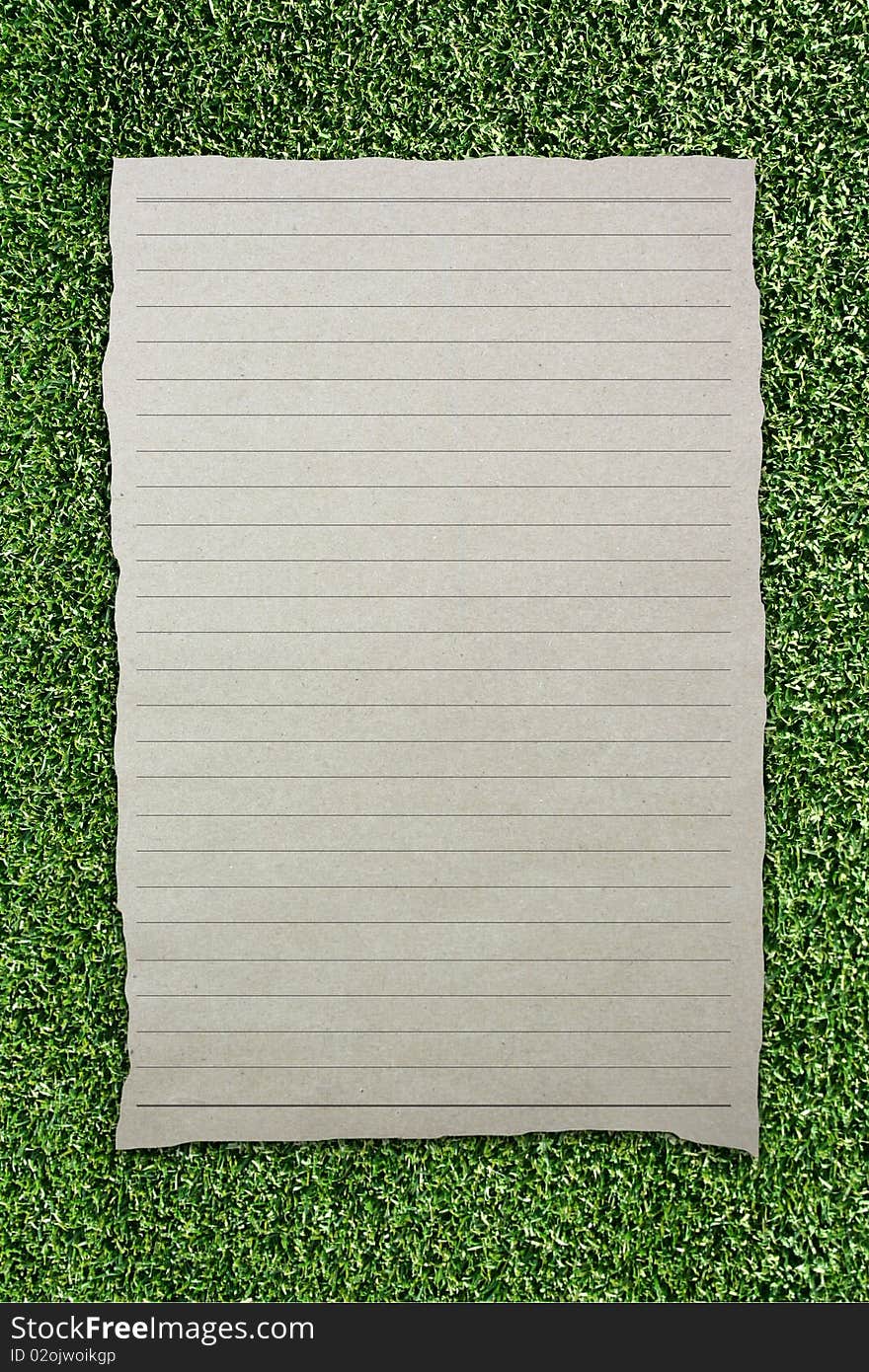 Tear Brown Paper With Line On Green Grass