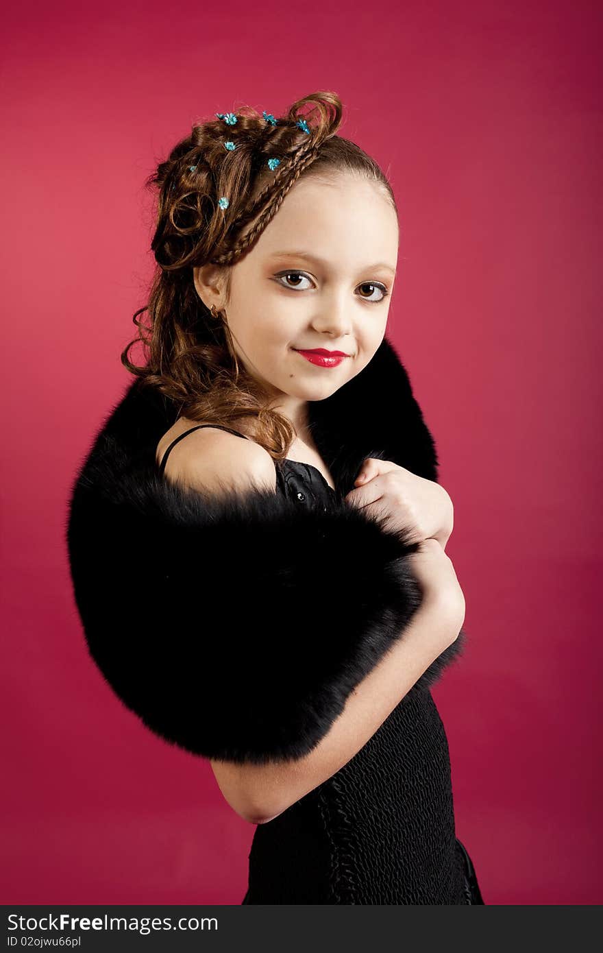 Young girl posing on red background