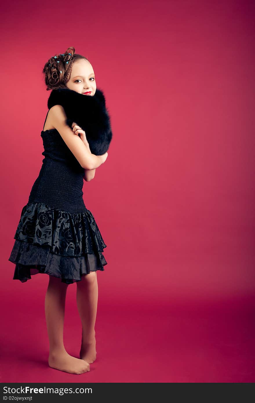 Young girl posing on red background