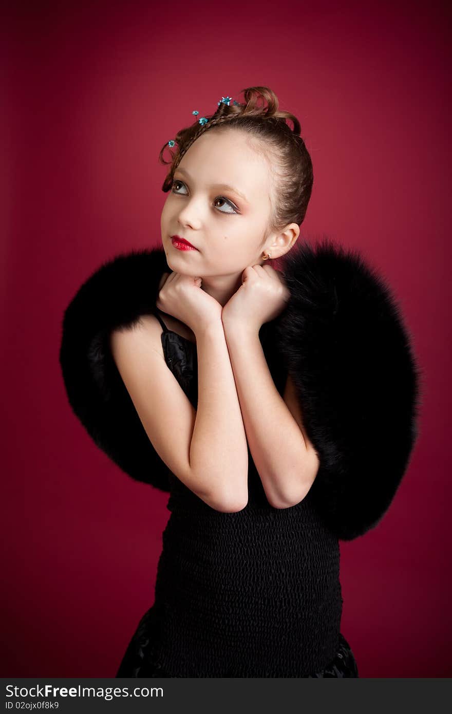 Young girl posing on red background