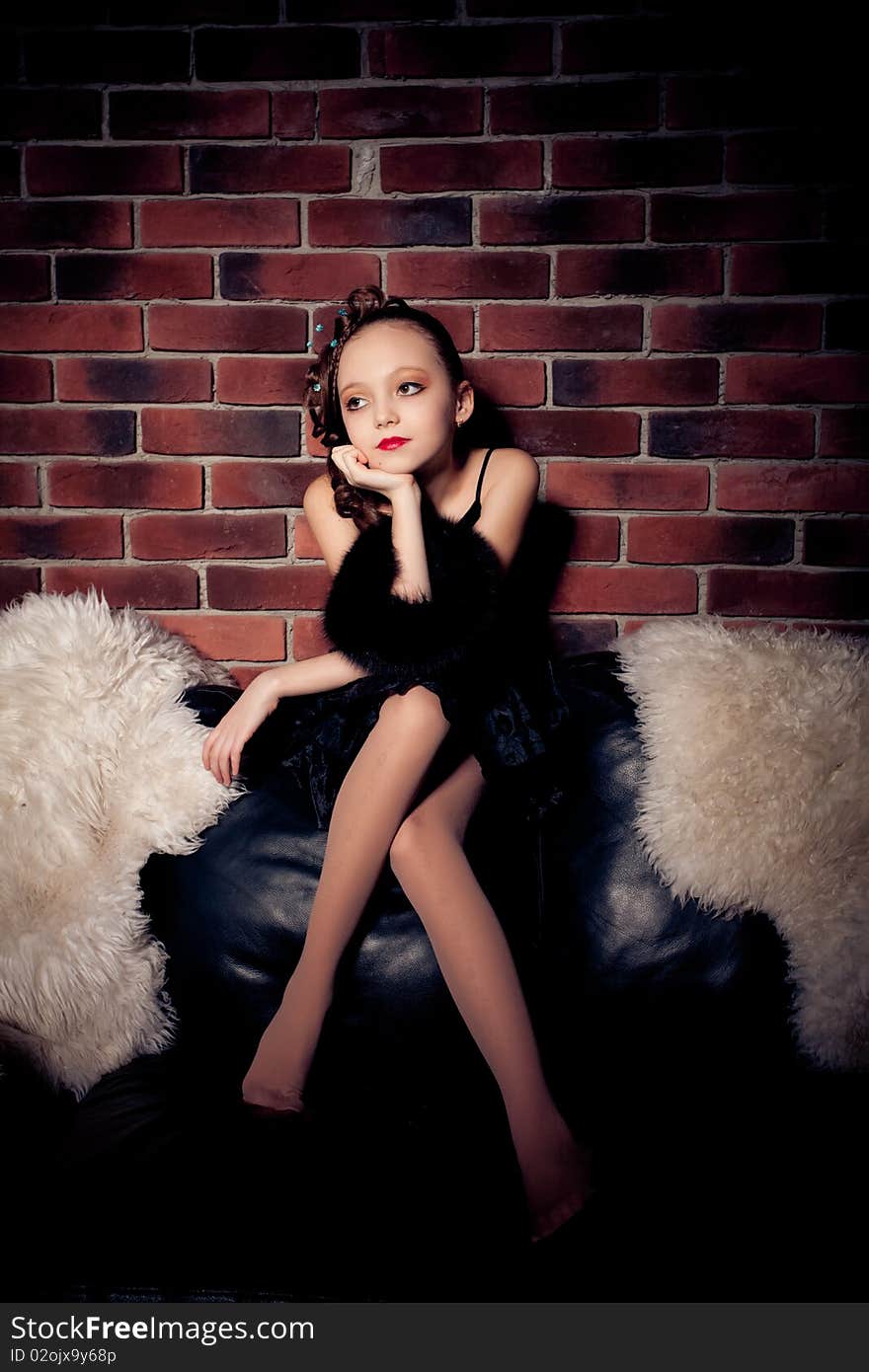 Young Girl Posing On Brick Wall Background