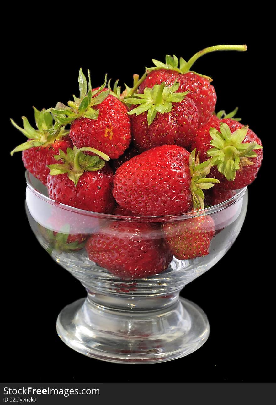 Juicy strawberry glass bowl isolated on black background