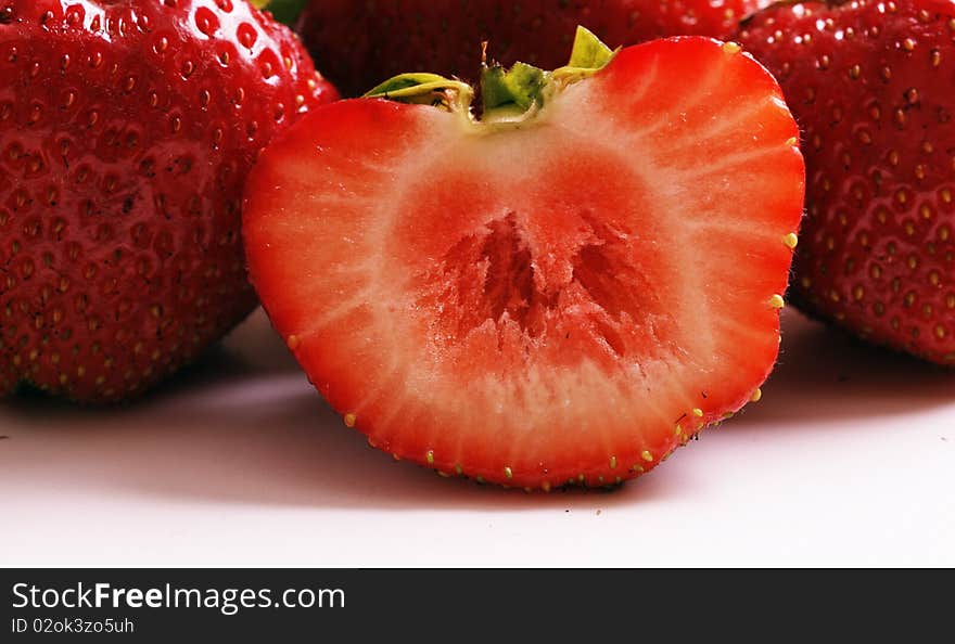 Strawberries close-up show, isolated on white