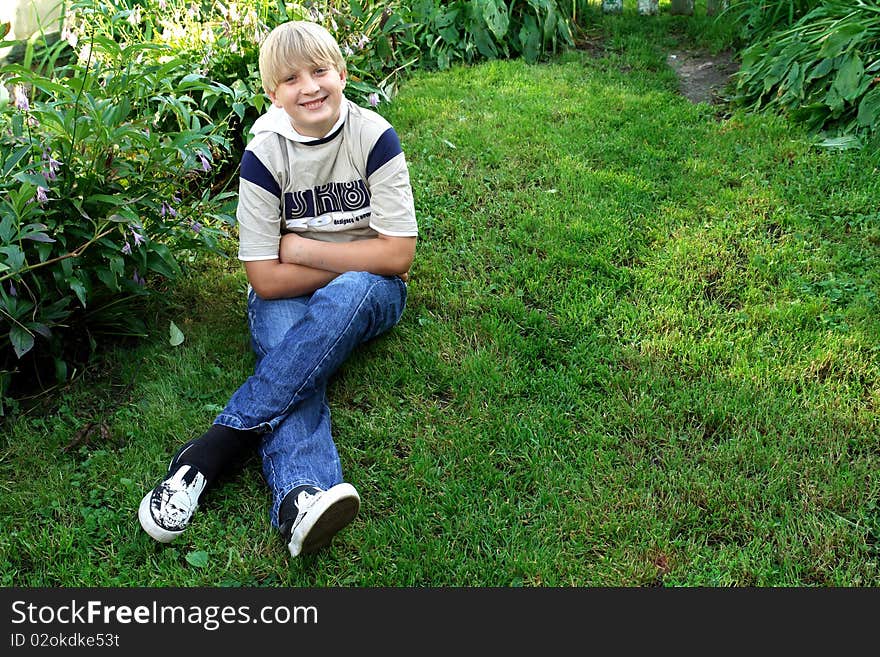 Portrait of a boy on a green lawn. Portrait of a boy on a green lawn