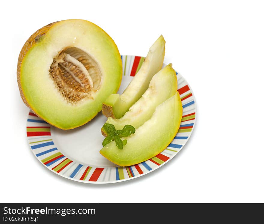 Melon slices in a plate isolated on white