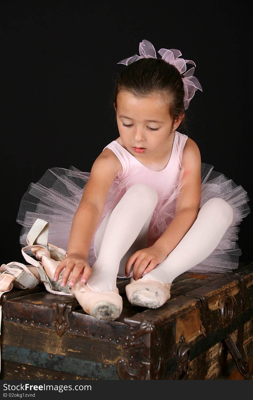 Cute little ballet girl trying on pointe shoes