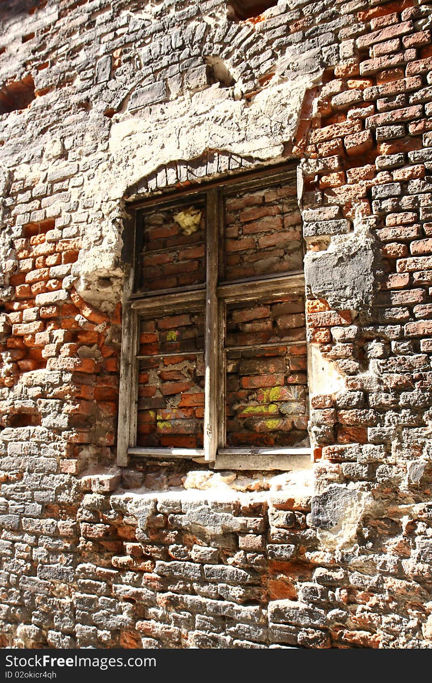 Old wooden window in an old brick wall