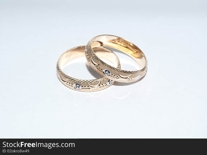 Gold wedding rings with identical designs. Gold wedding rings with identical designs.