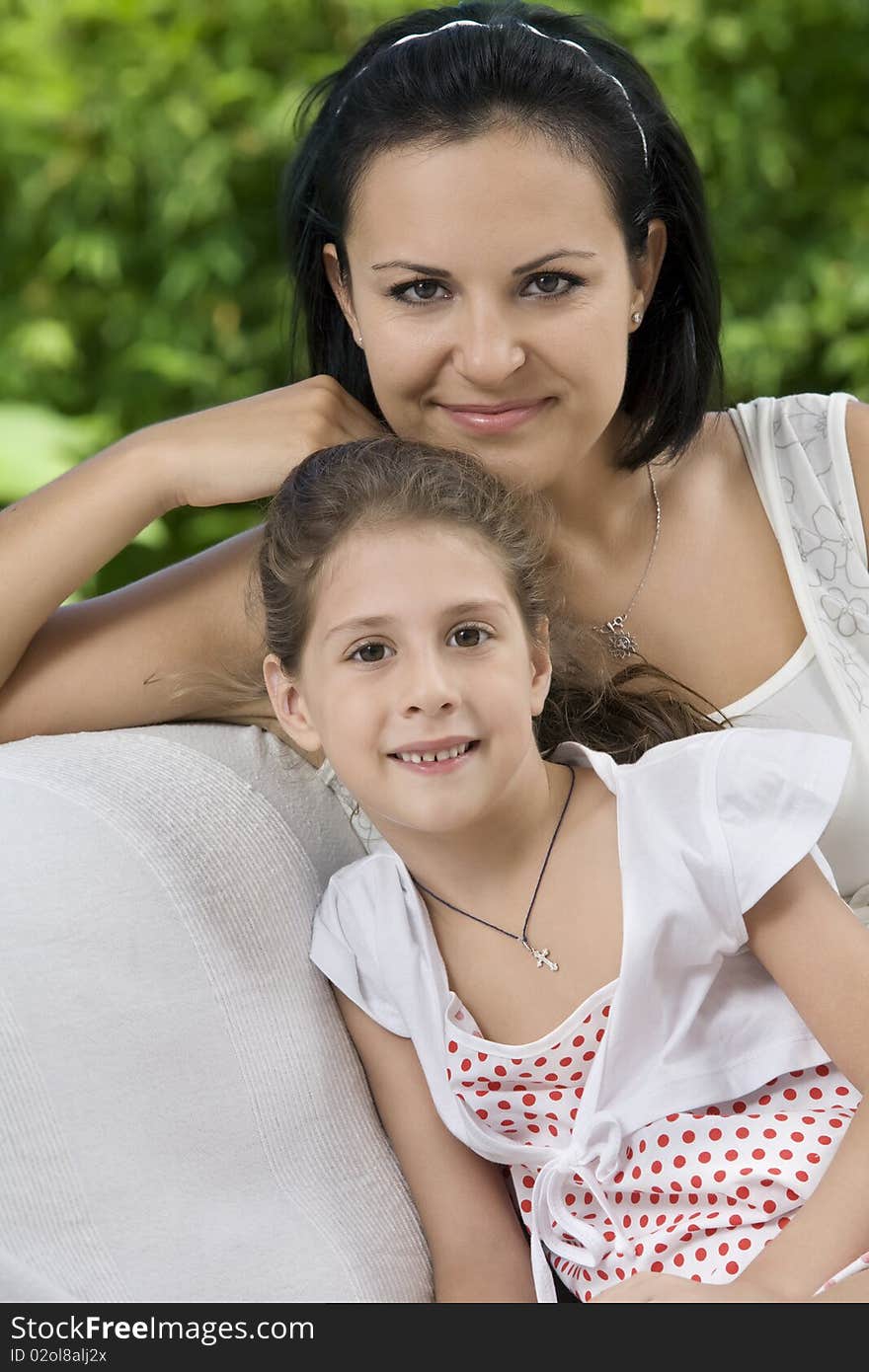 Portrait of happy mother with daughter having good time in summer environment. Portrait of happy mother with daughter having good time in summer environment